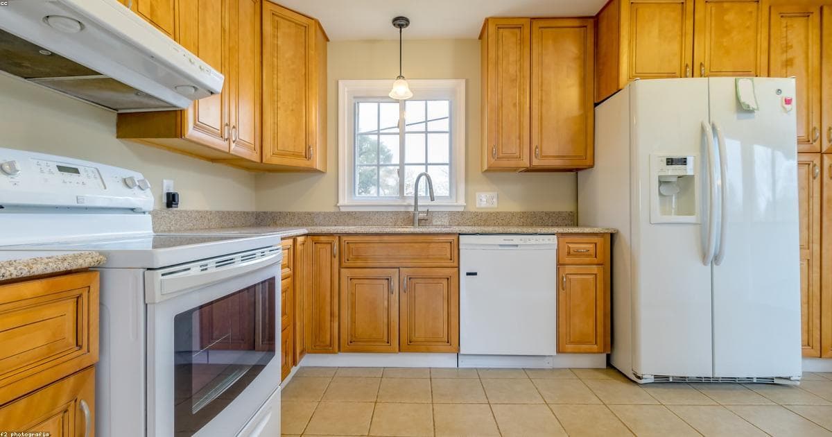 A house with a giant scissors cutting a mortgage document in half